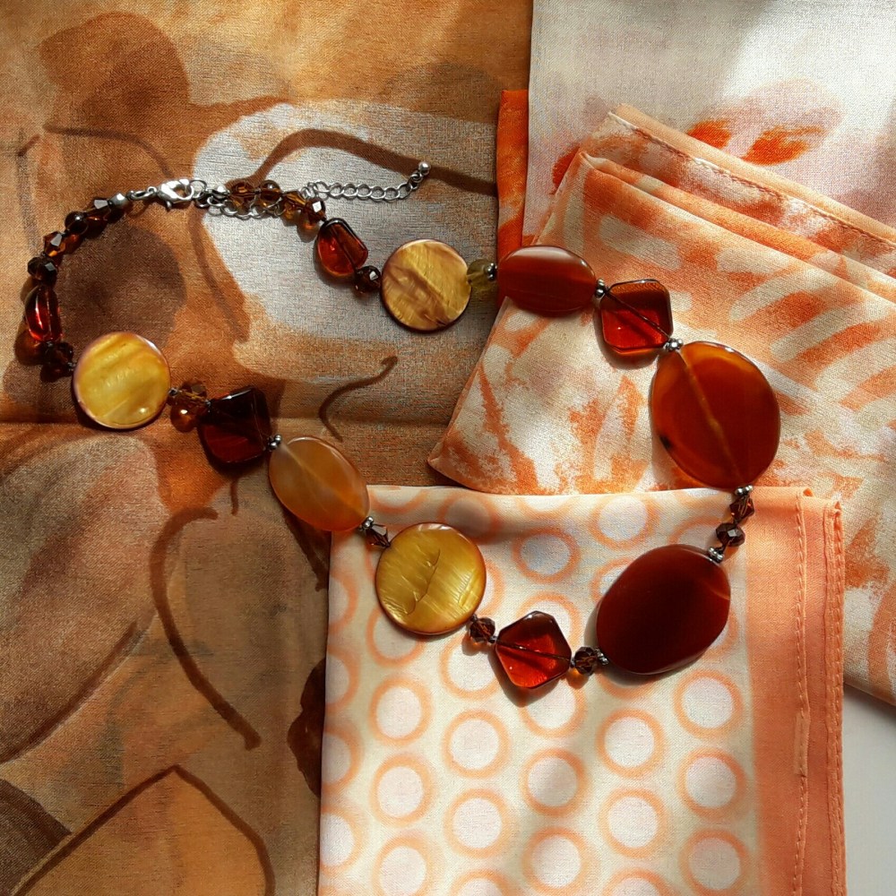 Collar naranja sobre pañuelos anaranjados